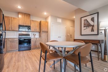 a kitchen and dining room with a table and chairs